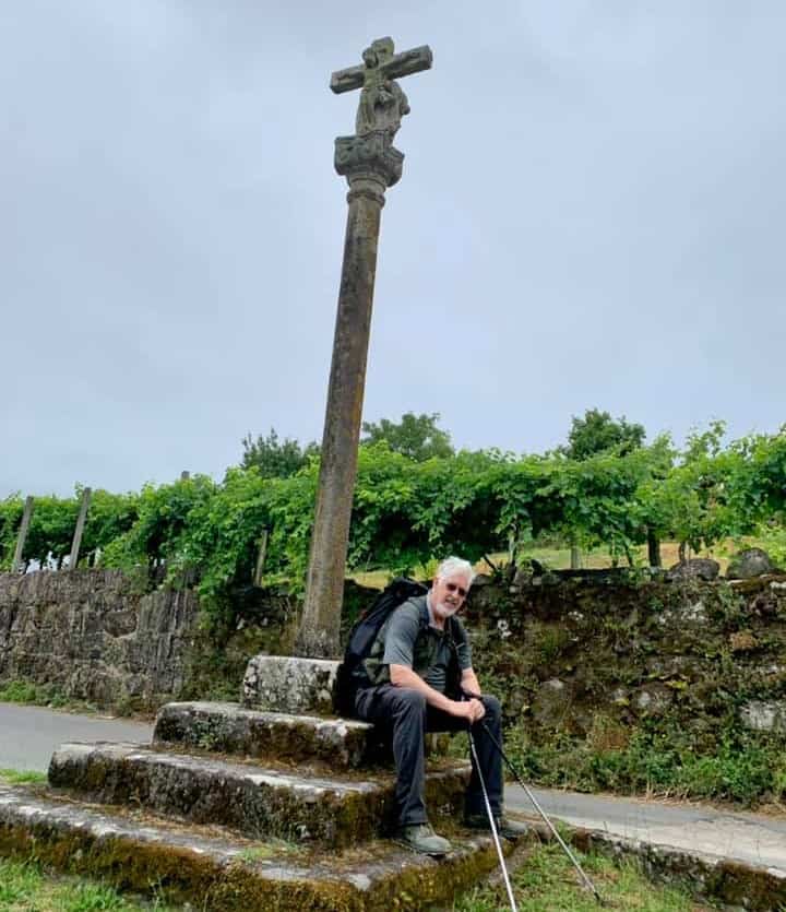 a picture of a pilgrim sitting in front of a religious structure